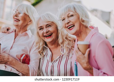 Waist Up Portrait Of Three Positive Older Women Joking And Having Fun Together