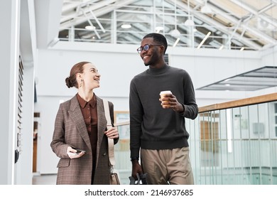 Waist Up Portrait Of Two Young Business People Walking Towards Camera In Office Building While Starting Work In Morning, Copy Space