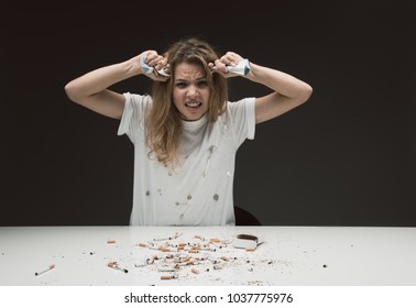 Waist Up Portrait Of Untidy Stressed Female Squeezing Cigarette Packs Expressing Rage. Isolated On Background