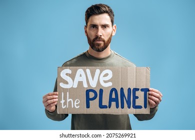 Waist Up Portrait View Of The Caucasian Worried Man Holding Carton Placard With Save The Planet Writing. Concept Of Nature Destruction And Eco Activism