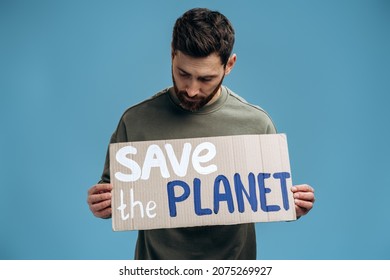 Waist Up Portrait View Of The Caucasian Worried Man Looking At The Carton Placard With Save The Planet Writing. Concept Of Nature Destruction And Eco Activism