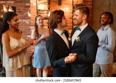 Waist Up Portrait Of Young Gay Couple Dancing Together During Wedding Ceremony With Friends, Copy Space