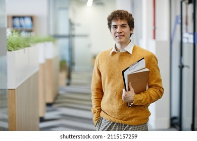 Waist Up Portrait Of Young Man In Office Looking At Camera, New Employee And Internship Concept, Copy Space