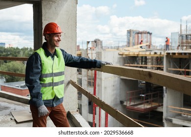Waist up portrait of young man working at construction site and looking at cityskape, copy space