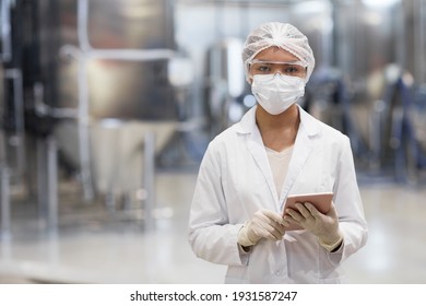 Waist Up Portrait Of Young Woman Working At Chemical Plant And Looking At Camera While Wearing Protective Clothing, Copy Space