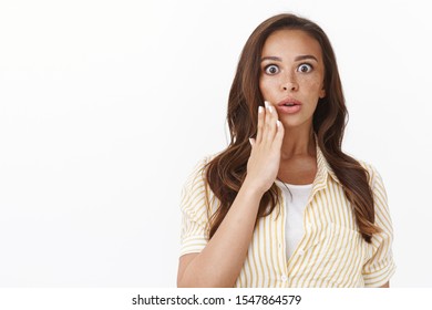 Waist-up Impressed Speechless Gasping Young Brunette Woman In Blouse Over T-shirt, Open Mouth And Stare Astonished, Hold Hand Near Lips Ambushed, Gossiping About Shocking Event