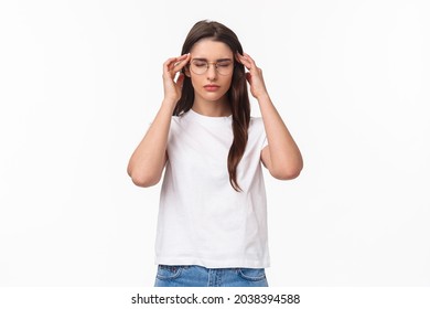 Waist-up portrait of attractive young woman trying get ready, massaging temples with closed eyes as relaxing, ease the pain, thinking rational, put effort into making up plan, white background