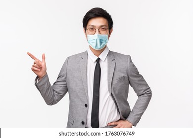 Waist-up portrait of handsome professional male entrepreneur showing new employee office, pointing finger left, look at chat, smiling at camera pleased and proud, standing white background - Powered by Shutterstock