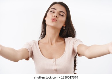 Waist-up Portrait Lovely, Sensual And Flirty Caucasian Woman In Dress, Stretch Hands Sideways, Reaching For Kiss, Folding Lip Blowing Mwah, Close Eyes Romantic, Standing White Background