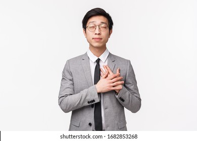 Waist-up Portrait Of Romantic Handsome Young Asian Male Entrepreneur, Office Manager Have Crush On His Coworker, Hold Hands On Heart Close Eyes, Daydreaming About Falling In Love, White Background