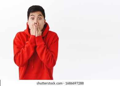 Waist-up Portrait Of Shocked Speechless Asian Man, Gasping, Cover Mouth And Stare Camera, Express Shook With Eyes, Gossipping, Heard Exciting Incredible News, Cant Believe, White Background