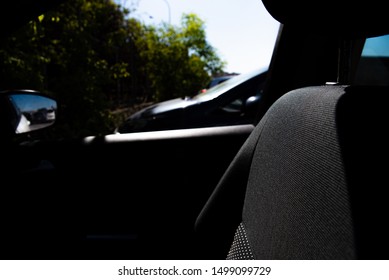 Wait inside a car looking out the window.