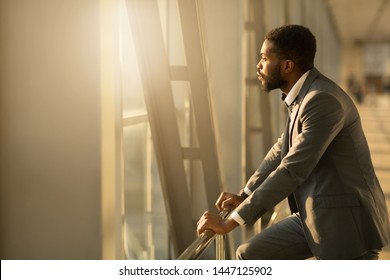 Wait for Plane. African-American Businessman Looking Through Window in Airport, Copy Space - Powered by Shutterstock