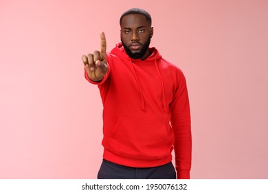 Wait second. Serious-looking annoyed strong brutal african american older brother show index finger number one explaining important rule look bossy solid, standing pink background forbid something - Shutterstock ID 1950076132