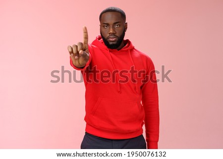 Wait second. Serious-looking annoyed strong brutal african american older brother show index finger number one explaining important rule look bossy solid, standing pink background forbid something