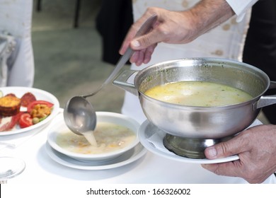 Waiter In Action, Pouring Soup In A Plate, Serving