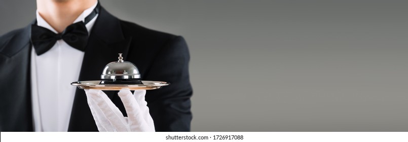 Waiter Or Butler With Hospitality Concierge Service Bell In Hand