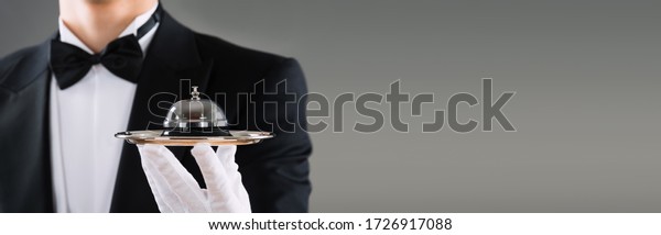 Waiter Or Butler With Hospitality Concierge Service\
Bell In Hand