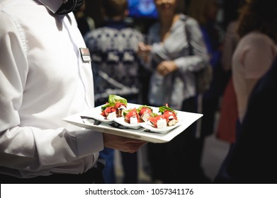 Waiter Carrying Trays With Food. Caterring Service For Wedding, Birthday Or Any Company Event