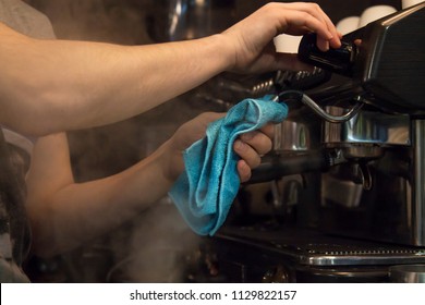 waiter cleaning coffee machine - Powered by Shutterstock