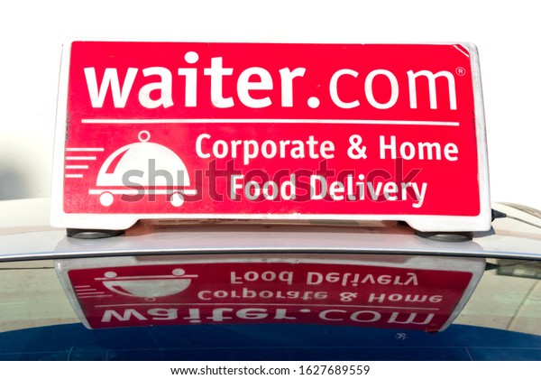 Waiter.com corporate\
and home food delivery service advertisement atop car rooftop - San\
Jose, CA, USA - 2020