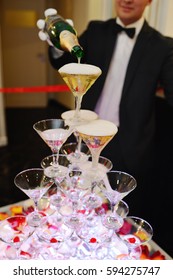 The Waiter Filled Champagne Fountain Pyramid Of Glasses