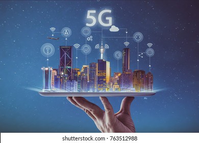 Waiter hand holding an empty digital tablet with smart city and 5G network wireless systems and internet of things . - Shutterstock ID 763512988