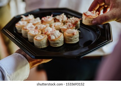 
Waiter Handing Out Canapes At An Event