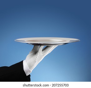 Waiter holding an empty silver platter ready for product placement