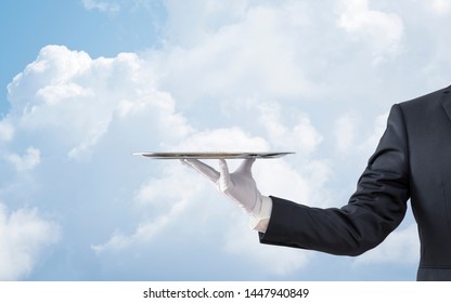 Waiter Holding Empty Silver Tray Over Blue Sky 