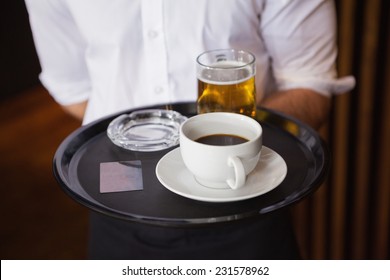 Waiter Holding Tray With Coffee Cup And Pint Of Beer In A Bar