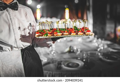 Waiter Holds Tray With Canape. Restaurant Service. Buffet Or Catering.