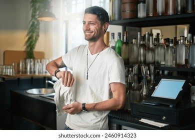 Waiter, man and cleaning a glass in cafe with smile for daydreaming and wondering with hygiene in small business. Bartender, person and happy in restaurant with polishing, disinfection and pub pride - Powered by Shutterstock