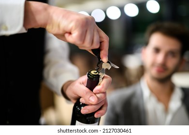 Waiter Opening A Bottle Of Red Wine