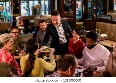 Waiter Passing A Plate Of Food