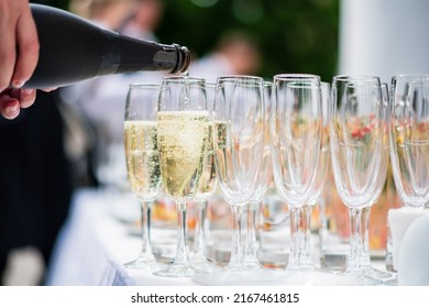 Waiter Pouring Champagne Into Glass