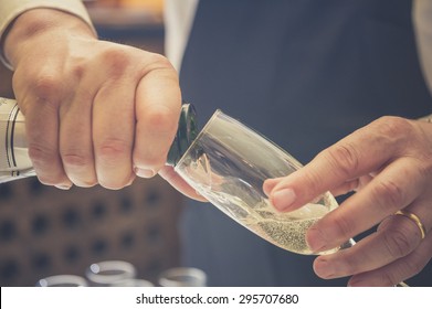 Waiter Pouring Champagne In The Party, Photo With Effect Vintage