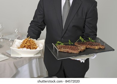 Waiter Serving An Entrecôte