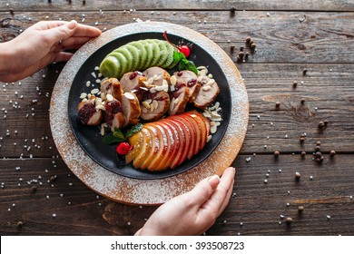 Waiter Serving Baked Veal For Retail. Chief Decorating Food For Presentation In Restaraunt. Waiter Serving Baked Veal With Fresh Fruits. 