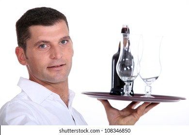 Waiter serving a bottle of beer