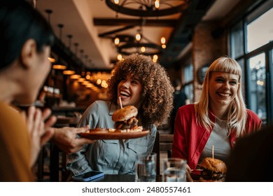 Waiter serving food to a group of customers at a restaurant