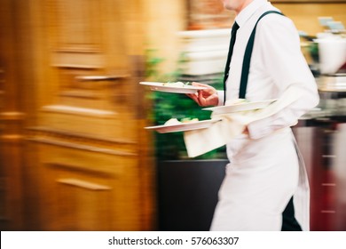 Waiter Serving In Motion On Duty in Restaurant Long Exposure