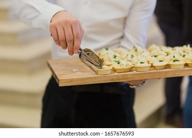 Waiter Serving Vegetarian Canapes At Celebration Event.