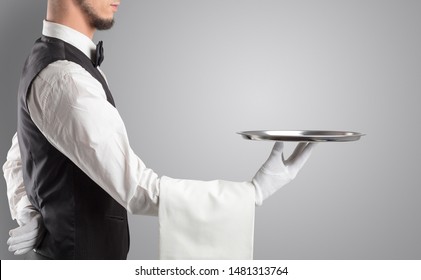 Waiter serving with white gloves and steel tray in an empty space - Shutterstock ID 1481313764