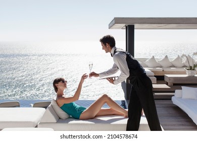 Waiter serving woman drinks outdoors - Powered by Shutterstock