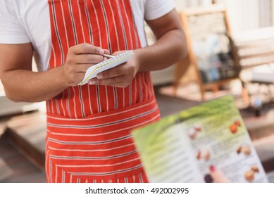 Waiter taking order from client - Powered by Shutterstock