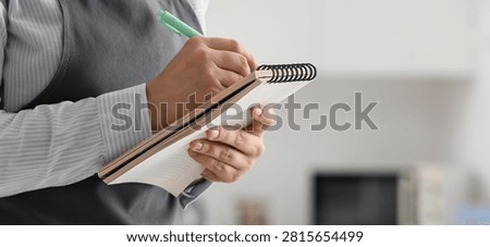 Waiter taking order with notepad and pen