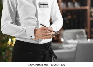 Waiter Taking Order In Restaurant