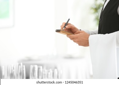 Waiter Taking Order In Restaurant