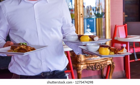 Waiter Walking With Food In Hands